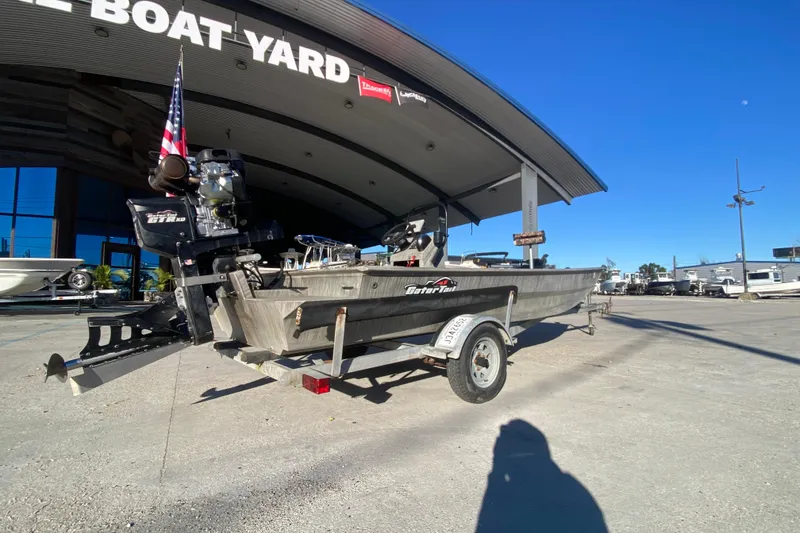 Slide: The Image of 2018 Gator Tail 17' boat on trailer at dealership, clear blue sky. - 3