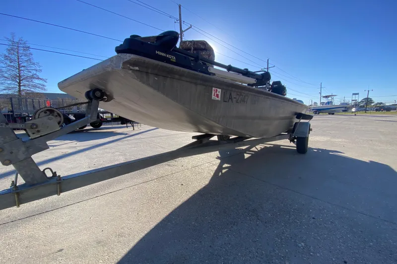 Slide: The Image of 2018 Gator Tail 17' boat on trailer in sunny outdoor setting. - 7