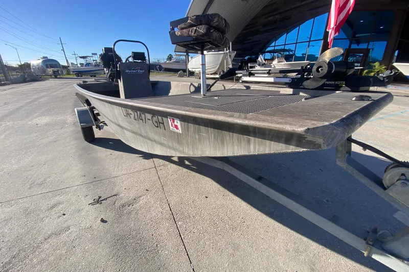 Slide: The Image of 2018 Gator Tail 17' boat on trailer, parked outdoors under clear blue sky. - 9