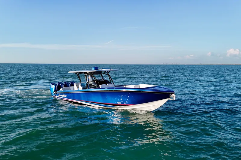 Slide: The Image of 2026 Nor-Tech 390 Sport Center Console boat cruising on open water. - 13