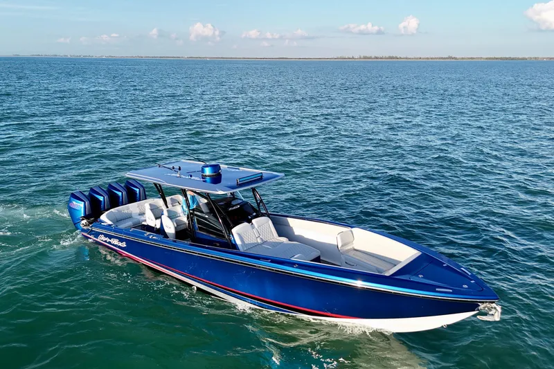 Slide: The Image of 2026 Nor-Tech 390 Sport Center Console boat cruising on open water. - 15