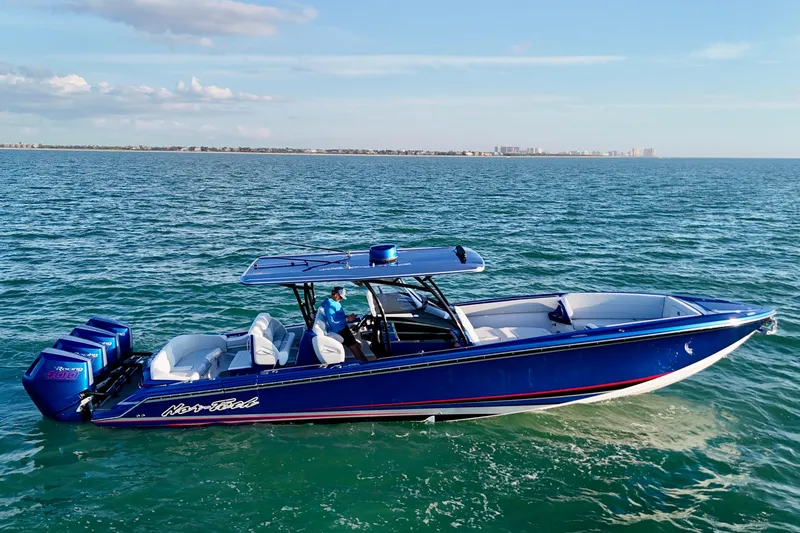 Slide: The Image of 2026 Nor-Tech 390 Sport Center Console boat cruising on open water, featuring sleek blue design. - 19