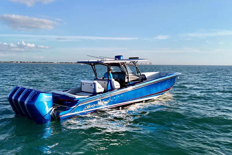 Slide: The Image of 2026 Nor-Tech 390 Sport Center Console boat cruising on open water. - 22