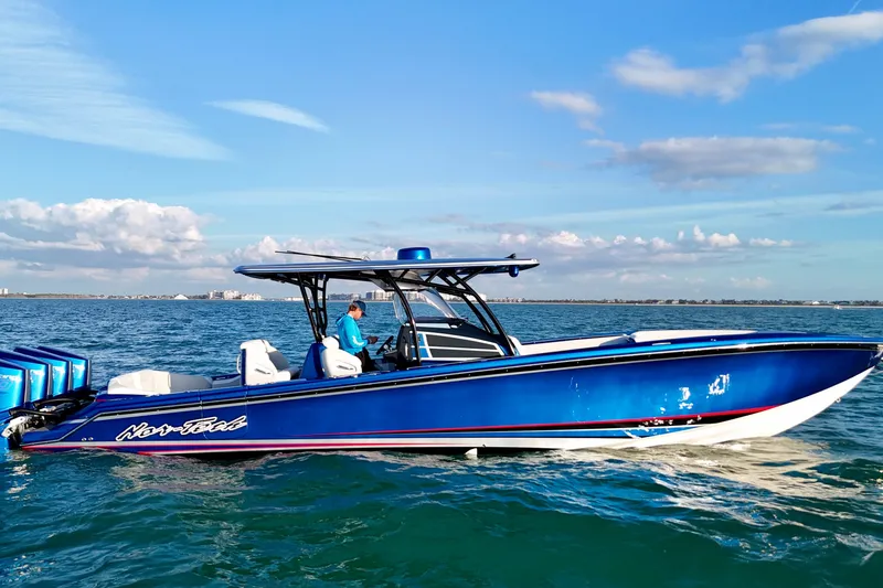 Slide: The Image of 2026 Nor-Tech 390 Sport Center Console boat on open water, blue exterior, clear sky. - 24