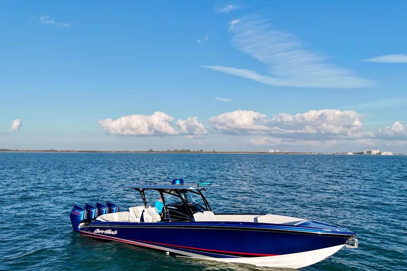Slide: The Image of 2026 Nor-Tech 390 Sport Center Console boat on open water under blue sky. - 25