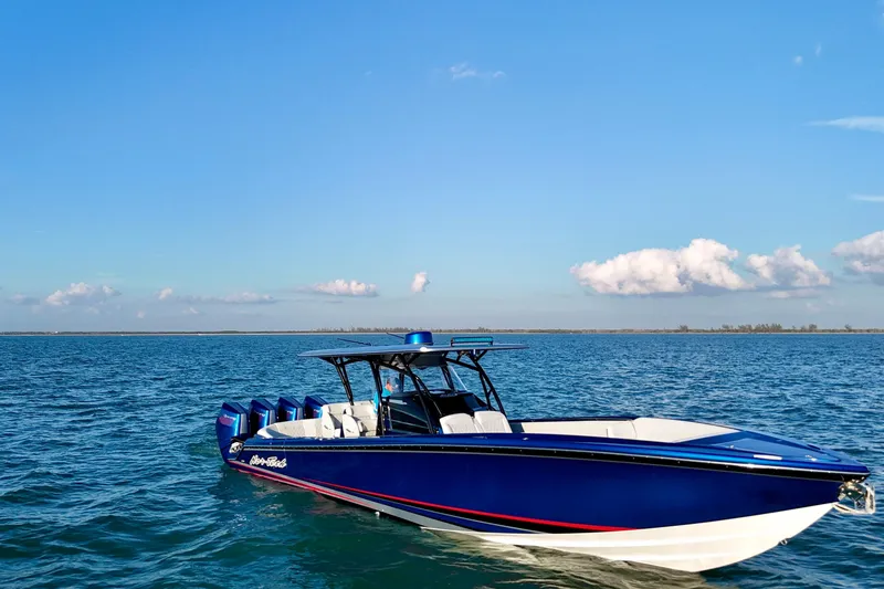 Slide: The Image of 2026 Nor-Tech 390 Sport Center Console boat on open water under clear blue sky. - 27
