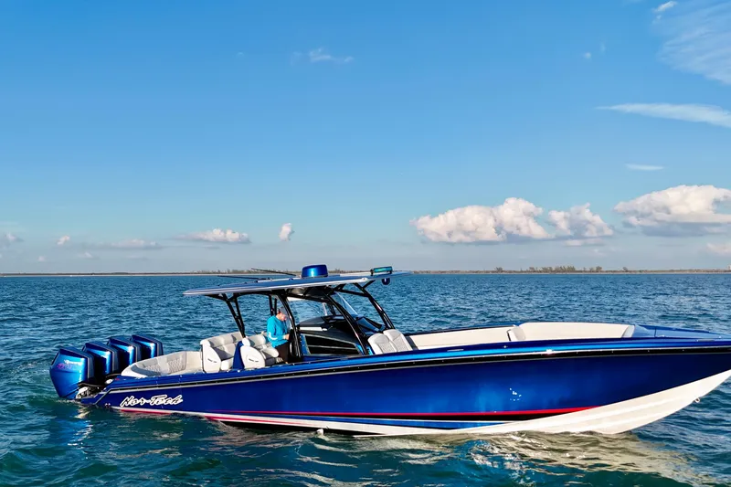 Slide: The Image of 2026 Nor-Tech 390 Sport Center Console boat on open water under blue sky. - 28