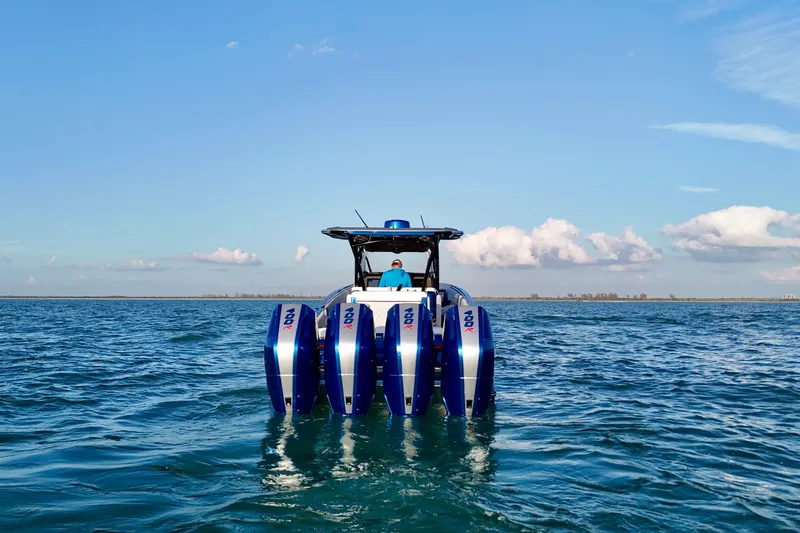 Slide: The Image of 2026 Nor-Tech 390 Sport Center Console boat with quad engines on open water. - 29