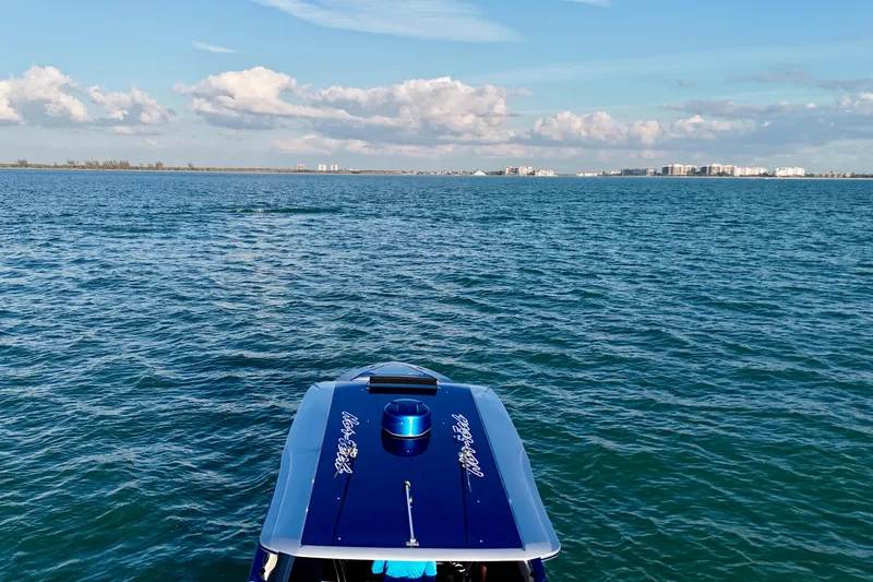 Slide: The Image of 2026 Nor-Tech 390 Sport Center Console on open water with city skyline. - 30