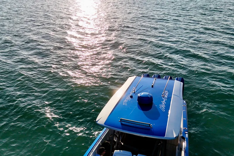 Slide: The Image of 2026 Nor-Tech 390 Sport Center Console on sunlit water. - 31