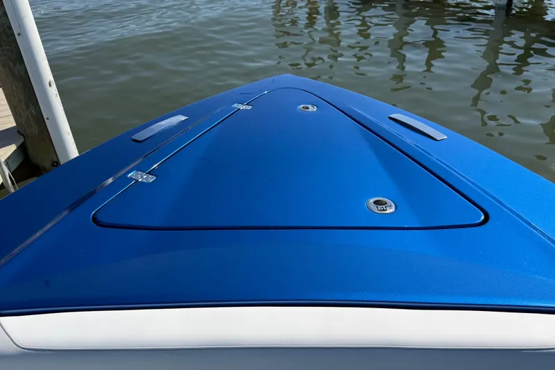 Slide: The Image of 2026 Nor-Tech 390 Sport Center Console boat bow, sleek blue design, docked by water. - 33
