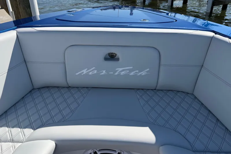 Slide: The Image of 2026 Nor-Tech 390 Sport Center Console interior with elegant seating and logo detail. - 34