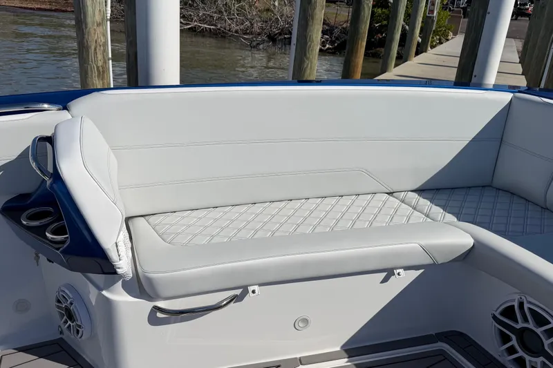Slide: The Image of Luxurious seating on 2026 Nor-Tech 390 Sport Center Console boat, featuring elegant design and cup holders. - 35