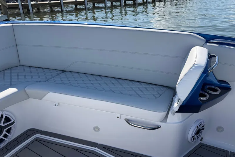 Slide: The Image of 2026 Nor-Tech 390 Sport Center Console boat seating with cup holders and speaker. - 36