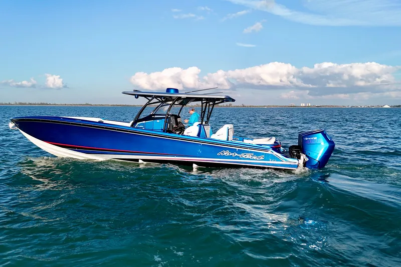Slide: The Image of 2026 Nor-Tech 390 Sport Center Console boat cruising on open water. - 4