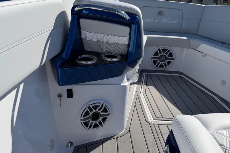 Slide: The Image of 2026 Nor-Tech 390 Sport Center Console interior with cup holders and speakers. - 40