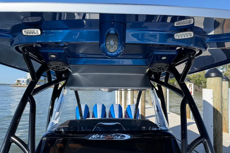 Slide: The Image of 2026 Nor-Tech 390 Sport Center Console boat interior with blue accents and advanced lighting. - 48