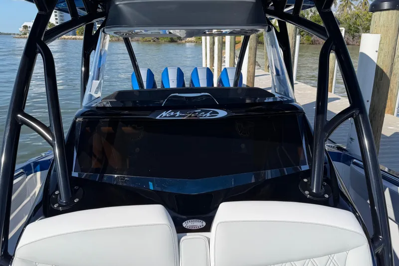 Slide: The Image of 2026 Nor-Tech 390 Sport Center Console boat docked by the water. - 49