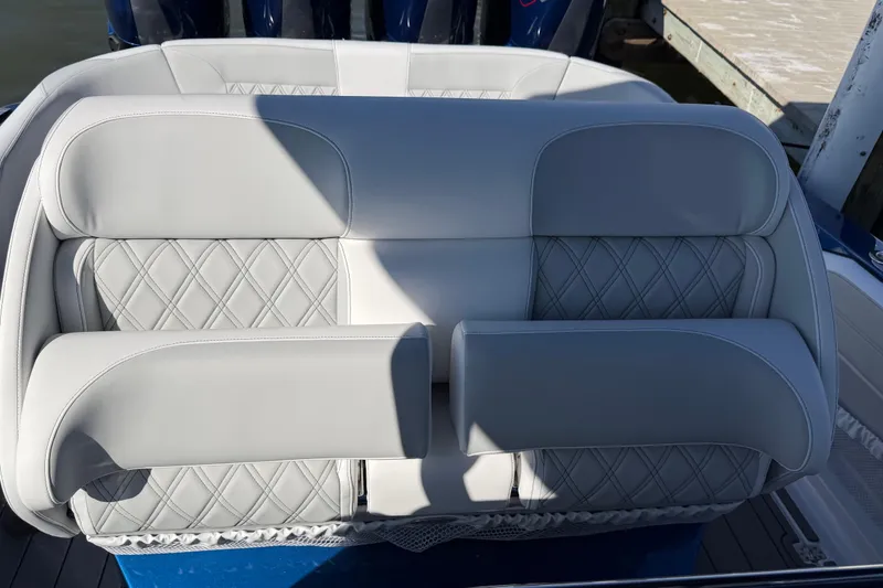 Slide: The Image of Luxurious seating on 2026 Nor-Tech 390 Sport Center Console boat, featuring diamond-stitched upholstery. - 54