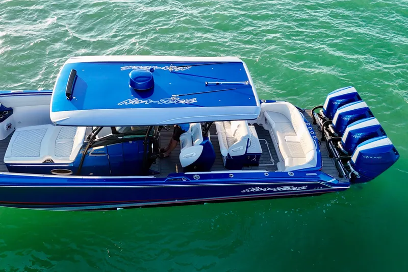 Slide: The Image of 2026 Nor-Tech 390 Sport Center Console boat on turquoise water, featuring sleek design and powerful engines. - 8
