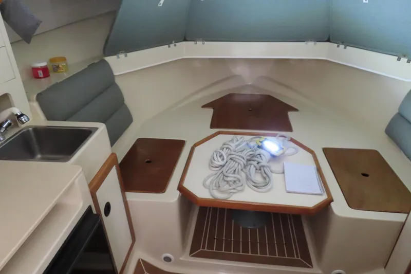 Slide: The Image of 2002 Albin 28 Tournament Express cabin interior with table, sink, and seating. - 8
