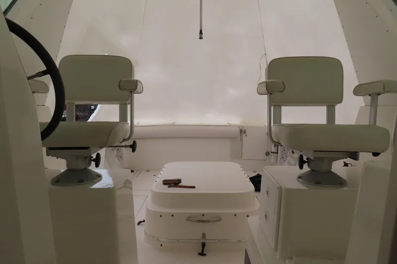 Slide: The Image of Interior of 2002 Albin 28 Tournament Express boat with white seating and steering wheel. - 9