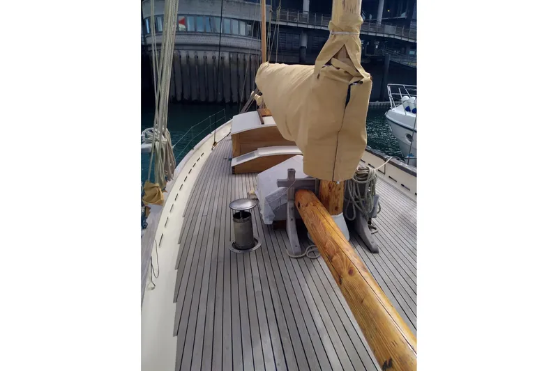 Slide: The Image of Deck of 2012 Custom Mayflower 50 sailboat with covered mast and wooden details. - 9