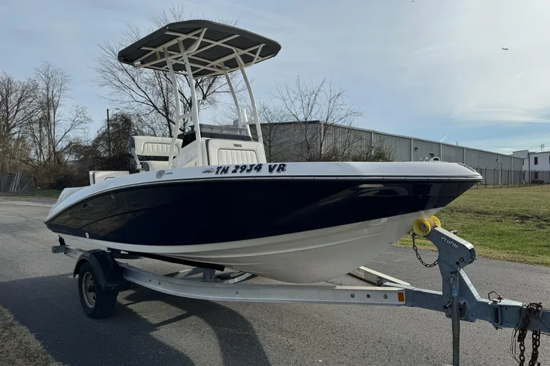 Slide: The Image of 2017 Yamaha Boats 190 FSH Sport on trailer, parked outdoors. - 2