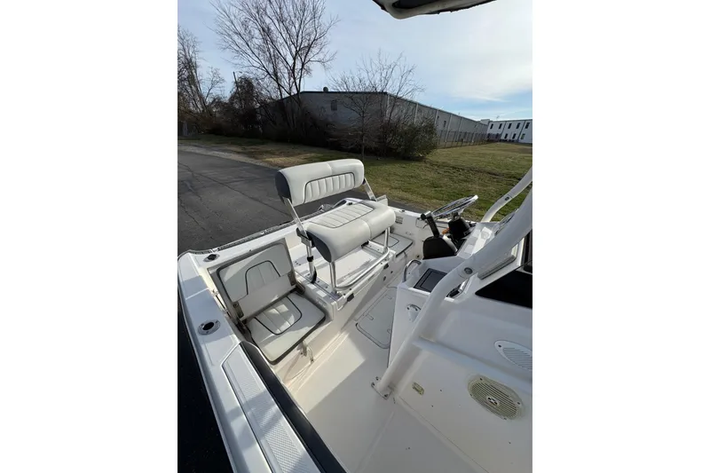 Slide: The Image of 2017 Yamaha Boats 190 FSH Sport interior with seating and steering wheel, outdoor setting. - 7