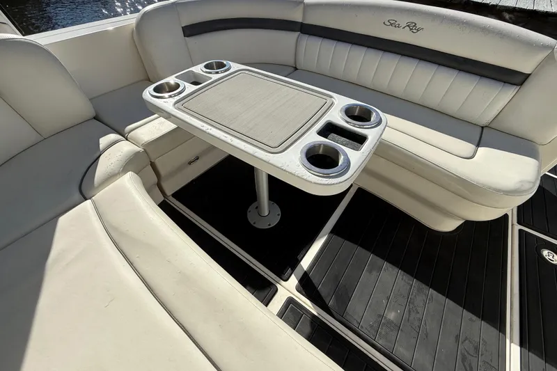 Slide: The Image of 2005 Sea Ray 390 Sundancer interior with cushioned seating and table with cup holders. - 10