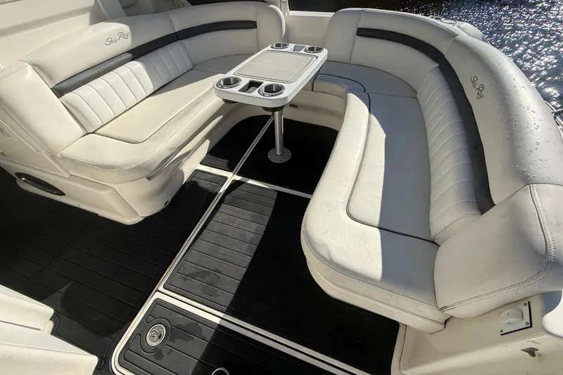 Slide: The Image of 2005 Sea Ray 390 Sundancer boat interior with white seating and table. - 11