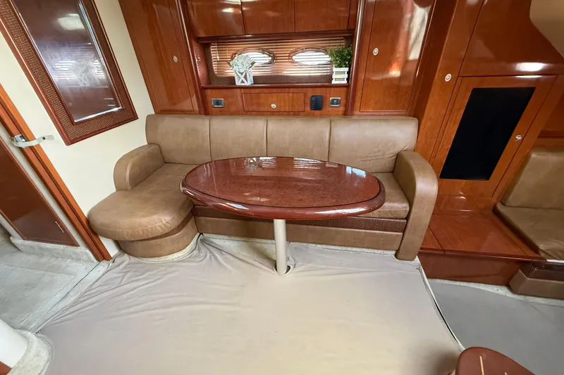 Slide: The Image of Luxurious interior of 2005 Sea Ray 390 Sundancer with elegant wood finishes and plush seating. - 17