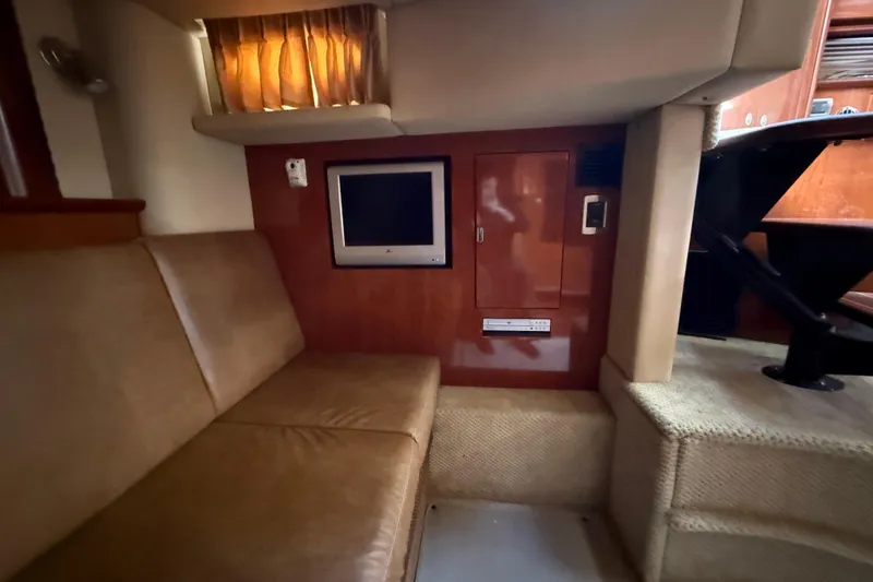 Slide: The Image of Interior of 2005 Sea Ray 390 Sundancer with sofa, TV, and wooden cabinetry. - 21