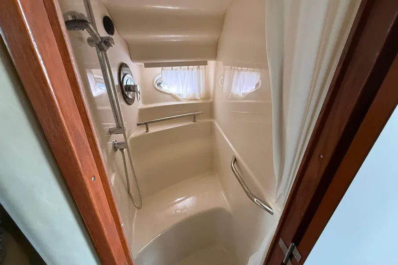 Slide: The Image of Shower area in 2005 Sea Ray 390 Sundancer yacht with curtain and porthole window. - 23