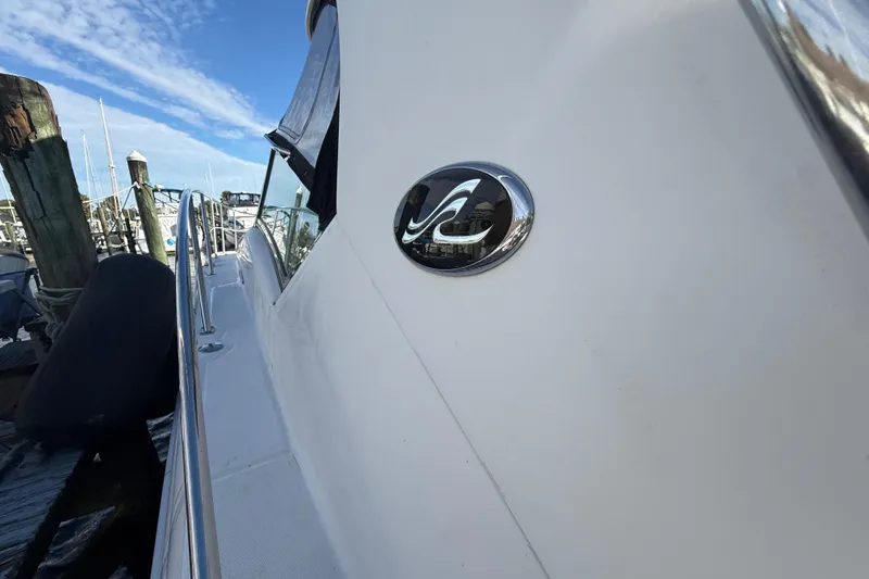 Slide: The Image of 2005 Sea Ray 390 Sundancer yacht docked at marina, side view with logo. - 4