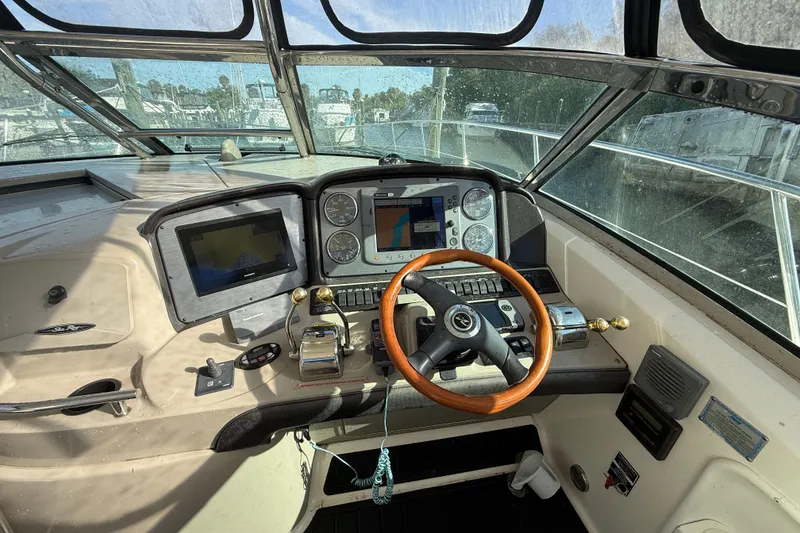 Slide: The Image of Helm of 2005 Sea Ray 390 Sundancer with navigation equipment and wooden steering wheel. - 6