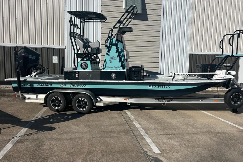 The Image of 2021 Shallow Stalker Cat 240 Pro Elite boat on trailer, parked outdoors. - 1