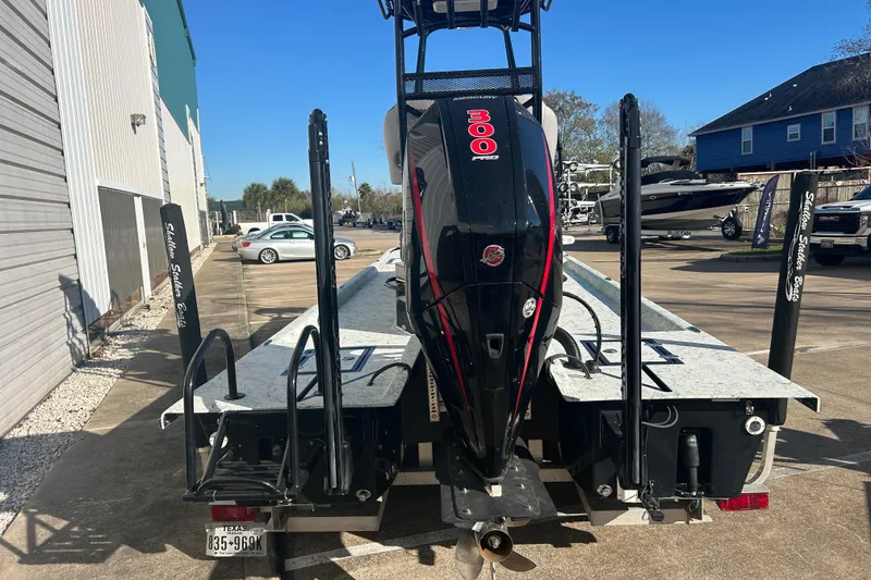 Slide: The Image of 2021 Shallow Stalker Cat 240 Pro Elite boat with Mercury 300 Pro engine, parked outdoors. - 11