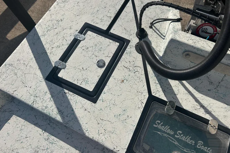 Slide: The Image of 2021 Shallow Stalker Cat 240 Pro Elite boat deck with storage hatch and branding. - 18