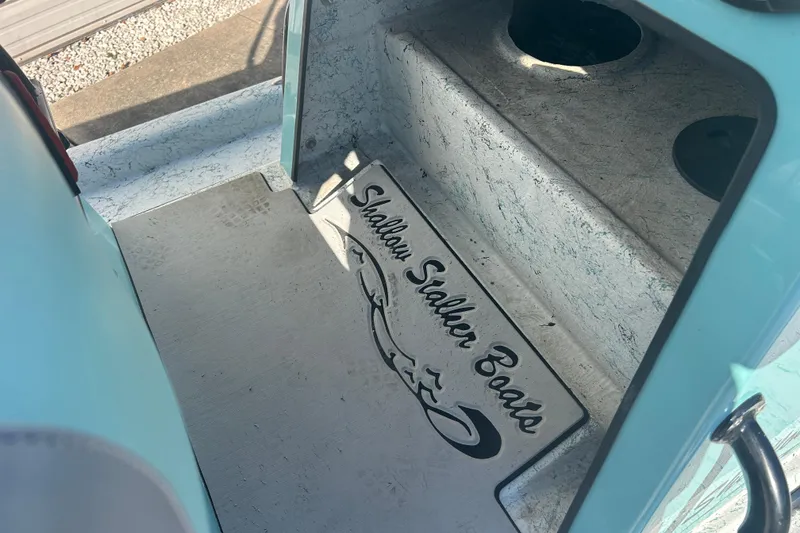 Slide: The Image of 2021 Shallow Stalker Cat 240 Pro Elite boat interior with logo detail. - 19