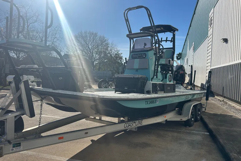 Slide: The Image of 2021 Shallow Stalker Cat 240 Pro Elite boat on trailer in sunny parking lot. - 2