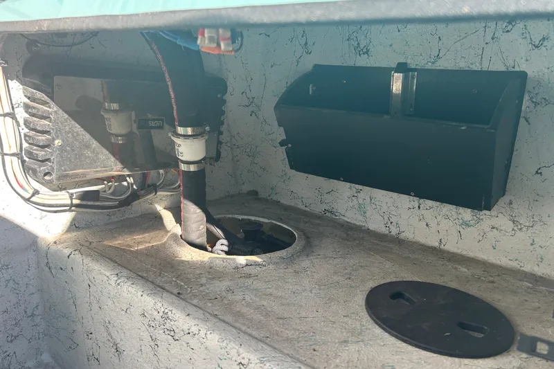 Slide: The Image of Interior view of a 2021 Shallow Stalker Cat 240 Pro Elite boat, showing wiring and storage compartment. - 24