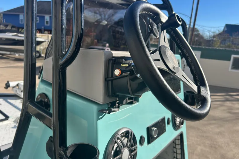 Slide: The Image of 2021 Shallow Stalker Cat 240 Pro Elite steering console with black wheel and controls. - 28