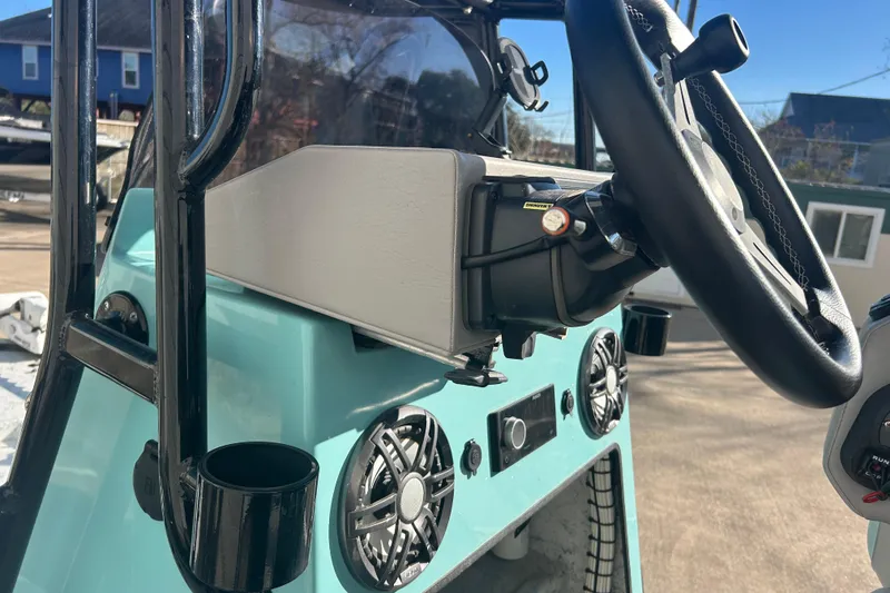 Slide: The Image of 2021 Shallow Stalker Cat 240 Pro Elite boat dashboard with steering wheel and controls. - 29