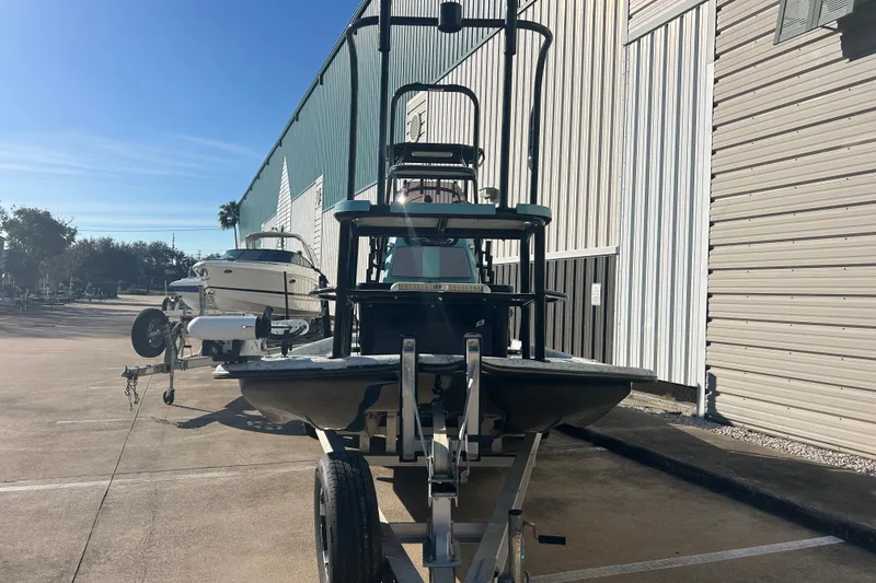 Slide: The Image of 2021 Shallow Stalker Cat 240 Pro Elite boat on trailer, parked outside a warehouse. - 3