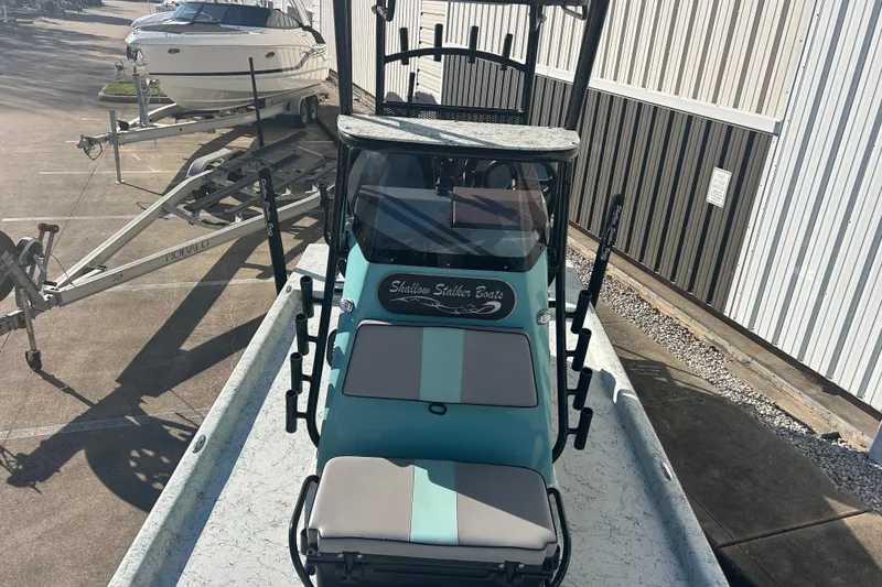 Slide: The Image of 2021 Shallow Stalker Cat 240 Pro Elite boat in a parking lot, front view. - 31