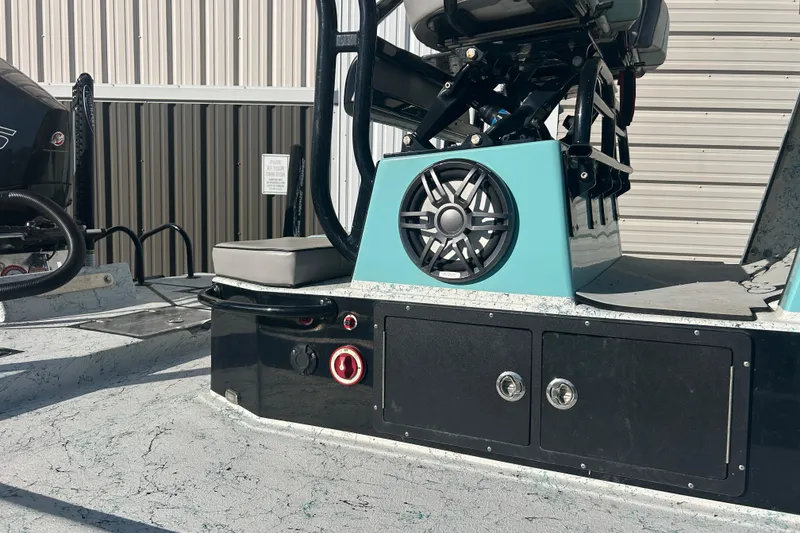 Slide: The Image of 2021 Shallow Stalker Cat 240 Pro Elite boat interior with speaker and storage compartments. - 8