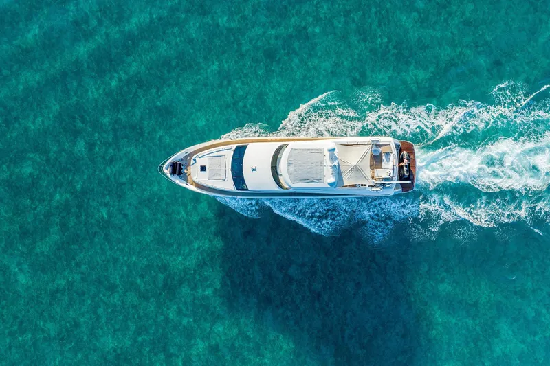 Slide: The Image of Aerial view of 2011 Princess 95 yacht cruising on clear turquoise waters. - 16