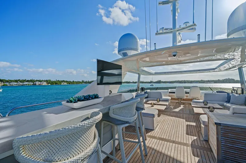 Slide: The Image of Luxurious 2011 Princess 95 yacht deck with seating, bar stools, and ocean view. - 25