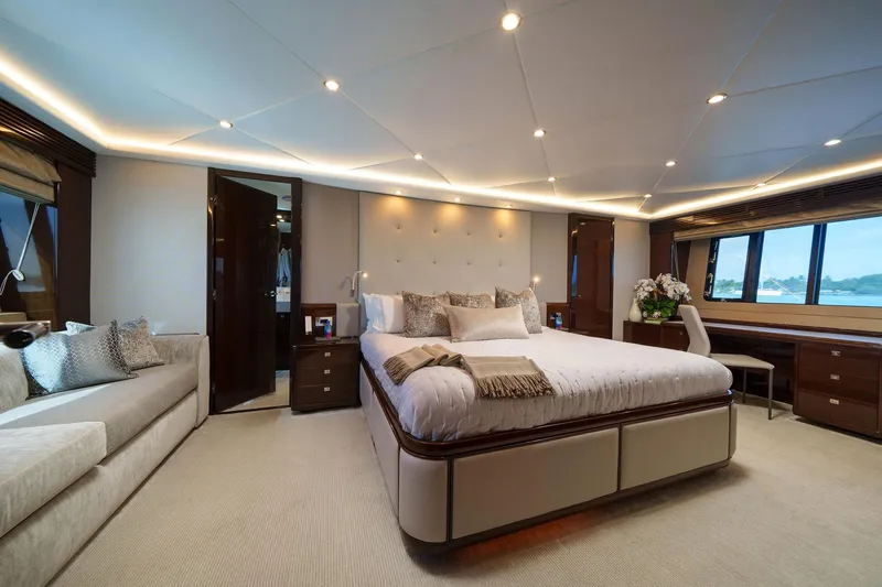 Slide: The Image of Luxurious bedroom interior on a 2011 Princess 95 yacht, featuring elegant decor and ample natural light. - 37